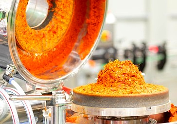 Red chili paste in an industrial grinding machine