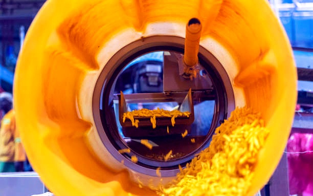 Corn snacks inside an industrial tumbling drum